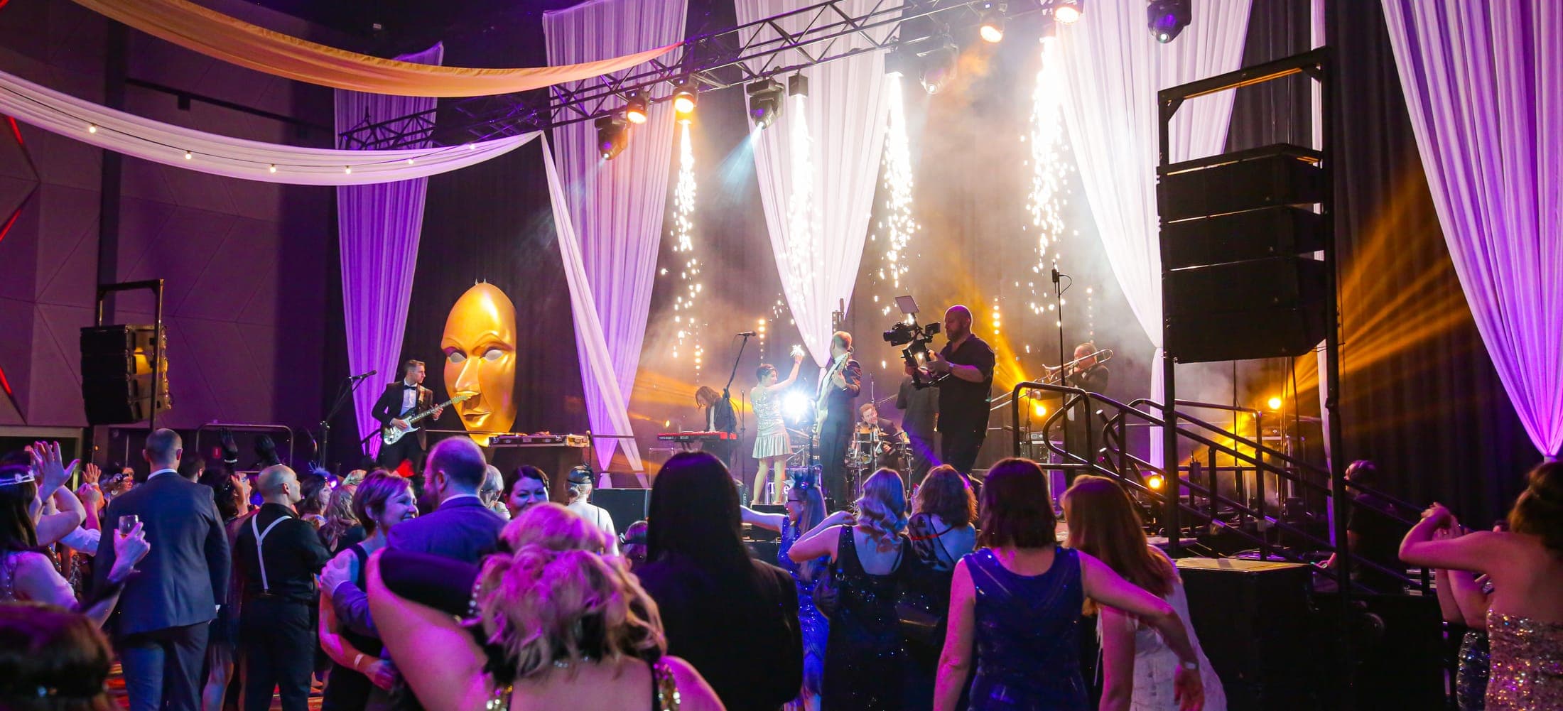 Live band and crowd under stage lighting at a night gala, Adelaide event photography